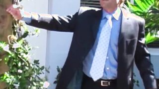 Businessman in a classy suit gets blowjob from gay buff dude