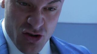 Muscular executive in a suit stuffing his cute buff employee