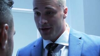 Muscular executive in a suit stuffing his cute buff employee