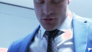 Muscular executive in a suit stuffing his cute buff employee