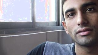 Unmarried Latino straight man soliciting money while baring his back