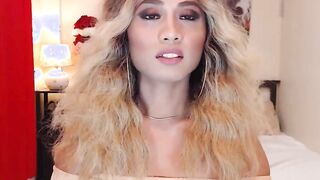 Blonde shemale wanks off in chair in front of webcam