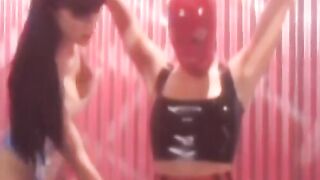 Playing with latex masks and dominatrix lesbian play