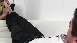 Handsome guy in a suit enjoys feet massage and toe sucking