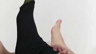 Handsome guy in a suit enjoys feet massage and toe sucking