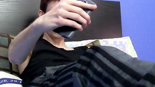 Cutie jerks off on the bed while holding a large dildo inside of him