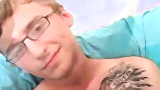 Geeky amateur with glasses and tattoos strokes his big cock