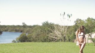 A sensual display of body language is made by a brunette babe in nature