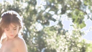 A sensual display of body language is made by a brunette babe in nature