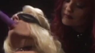 Redhead domina punishes a lesbian sub with a megadildo