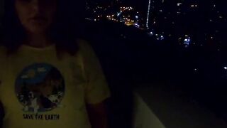 The women give a oral sex on a outdoors balcony, and then walks with a cum on her face