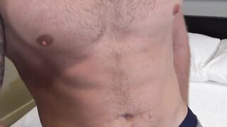 The muscular Logan Carter displays his abs and jerks himself off in front of the came