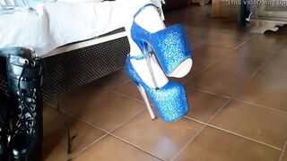 Laura is wearing miniskirt, pantyhose and 8 inches high heels