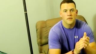Horny muscled Kyle giving pleasure to himself by stroking his big cock on the bed