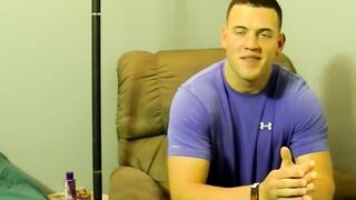 Horny muscled Kyle giving pleasure to himself by stroking his big cock on the bed