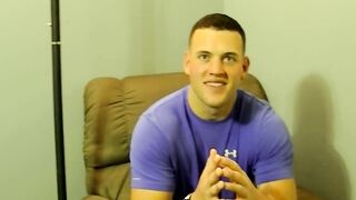 Horny muscled Kyle giving pleasure to himself by stroking his big cock on the bed