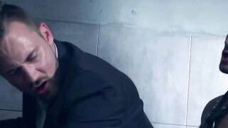 Leather clad Dato Foland pounds the warm ass hole of suited Logan Moore