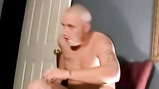A bald black dude with a massive cock rubbing it til he cums