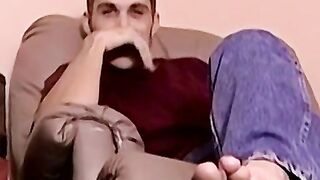 Moustached guy jerks off in his comfy couch
