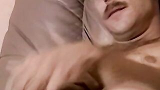 Moustached guy jerks off in his comfy couch