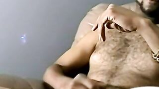 Muscular dude plays with himself in his sofa