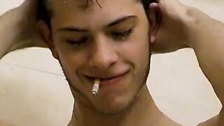 Sexy Bleu is blowing smoke and stroking his cock in the while taking a shower