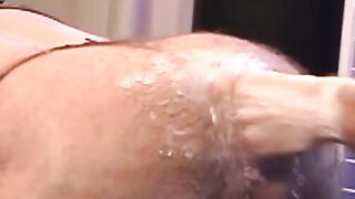 Hunky homosexual in his jockstrap endures having his ass fist fucked by his buddy who