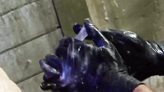 The accessories are black, black boots, a black jockstrap, and black-gloved hands dem