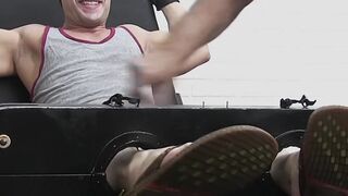 Restrained hunk laughs while tickle tormented by his dom