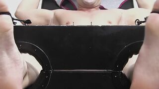 Restrained hunk laughs while tickle tormented by his dom