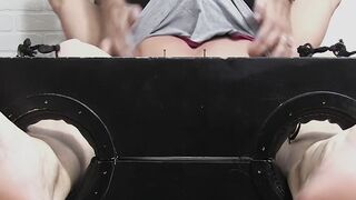 Restrained hunk laughs while tickle tormented by his dom