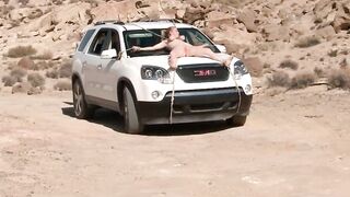 Man torments busty babes in a desert