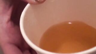Japanese dollface tops a cup off with her pee and records it