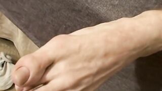 Athletic dude Scottie Blaze strips slowly on the bed and shows off his smooth feet