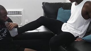 Black gay masturbates while his buddy is licking his feet