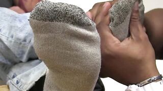 Black man enjoys licking bare feet and toes of his lover