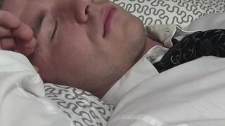 Hunk is asleep while man sniffs and licks his feet and toes