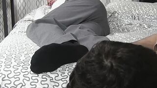 Hunk is asleep while man sniffs and licks his feet and toes