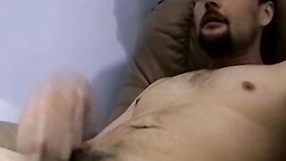 Bearded amateur plays with his dick and cums on himself