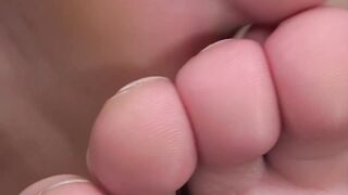 Hunky muscular man massages his own feet solo and relaxes