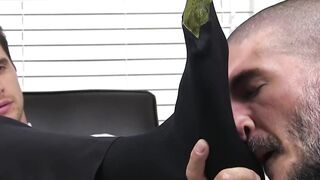 Hunky guy in a suit has his feet and toes licked sensually