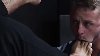 Bearded guard Rikk York receives foot licking from prisoner