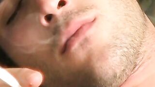 Hottie Cody lights his red cig while stroking his pinkish cock