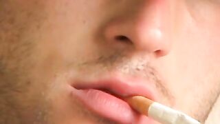 Hottie Cody lights his red cig while stroking his pinkish cock