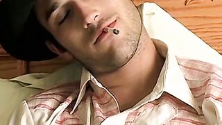 Hottie Cody lights his red cig while stroking his pinkish cock