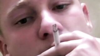 Twink savors the pleasure of smoking and stroking cock