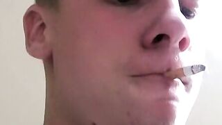 Twink savors the pleasure of smoking and stroking cock