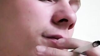 Twink savors the pleasure of smoking and stroking cock