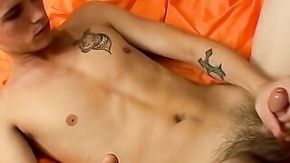 Inked skinny Cain jacks off his big cock before using a FleshJack to cum