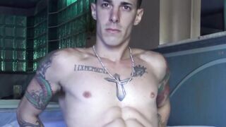 Inked guy Tattoo Boy strokes his cock intensely after a short photoshoot